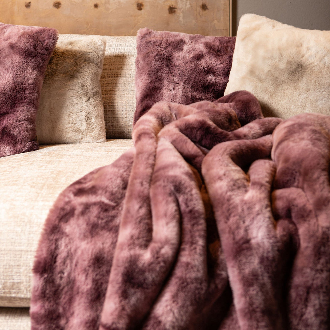 Linde Plaid Burgundy Fluweel 150x200cm van PTMD, burgundy plaid op een creme bank met kussens
